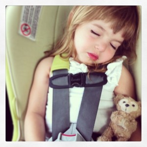 Asleep in her car seat with a bear